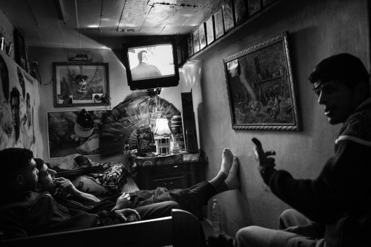 fot. Romain Laurendeau, z projektu Kho, the Genesis of a Revolt, World Press Photo Story of the Year 2020Według raportu UNESCO, 72% Algierczyków poniżej 30 roku życia jest bezrobotnych. Wydarzenia „Czarnego października” z 1988 r., pozostały w pamięci Algierczyków i nadal wzbudzają gniew.  Brutalnie reakcja władzy i  żniwo ponad 500 zabitych w ciągu pięciu dni zapoczątkowały okres zwany „czarną dekadą” przemocy i niepokojów. Po trzydziestu latach skutki tych wydarzeń są nadal obecne. Wysokie bezrobocie prowadzi do frustracji w codziennym życiu, a wielu młodych ludzi czuje się odłączonych od państwa i jego instytucji. W biednych dzielnicach klasy robotniczej, takich jak Bab el-Oued w Algierze, młodzi ludzie szukają schronienia w diki (prywatnych miejscach), które są dla nich „bańkami wolności”, z  dala od spojrzenia społeczeństwa i konserwatywnych wartości społecznych. Jednak to kruche poczucie wspólnoty i solidarności często nie wystarcza, aby złych warunkach życia. W lutym 2019 r. tysiące młodych ludzi z dzielnic robotniczych ponownie wyszło na ulice, co stało się ogólnokrajowym wyzwaniem pod rządami długoletniego prezydenta Abdelaziza Boutefliki.Kho w potocznym języku Afryki oznacza „brat”. Opowiada o genezie buntu. Jest to historia głębokiego niepokoju młodych, którzy znajdują odwagę by rzucić wyzwanie dotychczasowym autorytetom i stają się inspiracją dla reszty populacji. Daje to początek największemu ruchowi protestacyjnemu w Algierii od dziesięcioleci.