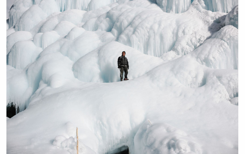 fot. Ciril Jazbec, Słowenia, z cyklu: One Way to Fight Climate Change: Make Your Own Glaciers dla National Geographic, nominacja w kategorii Środowisko - seria zdjęć / World Press Photo 2021

Gdy himalajskie śniegi maleją, a lodowce ustępują, społeczności w regionie Ladakh w północnych Indiach budują ogromne lodowe stożki, które zapewniają wodę w lecie. Ladakh to zimna pustynia, z temperaturami zimą sięgającymi -30°C i średnimi opadami deszczu wynoszącymi około 100 milimetrów. Większość wiosek boryka się z dotkliwym brakiem wody, szczególnie w kluczowym okresie sadzenia roślin w kwietniu i maju. W 2013 roku Sonam Wangchuk, inżynier i innowator z Ladakhi, wymyślił metodę tworzenia sztucznych lodowców w formie stożkowatych zwałów lodu, przypominających buddyjskie stupy religijne. Lodowe stupy magazynują zimową wodę roztopową i powoli uwalniają ją wiosną, w okresie wegetacyjnym, kiedy jest ona najbardziej potrzebna do upraw. Stupy powstają w zimie, kiedy woda jest odprowadzana podziemnymi rurami z wyżej położonych terenów. Końcowy odcinek wznosi się pionowo, a różnica wysokości powoduje, że w temperaturach poniżej zera woda tryska na zewnątrz, zamarzając i tworząc stupę. Stupy zostały zbudowane w 26 wioskach w 2020 roku, a obecnie trwa budowa rurociągu, który ma stworzyć 50 kolejnych. Wangchuk, mówi, że stupy stanowią ostatnią szansę himalajskich społeczności górskich na walkę z kryzysem klimatycznym, ale nie powinny być traktowane jako rozwiązanie tego problemu: pozostaje to w gestii rządów krajowych, a także ludzi prowadzących przyjazny dla środowiska styl życia w celu zmniejszenia emisji.
