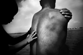 I nagroda w kategorii ''Życie codzienne - pojedyncze zdjęcie''. Fot. Justin Maxon, USA, Aurora Photos. Mui bezdomna nosicielka wirua HIV i jej son kąpią się nad brzegiem Czerwonej Rzeki - Hanoi, Wietnam.