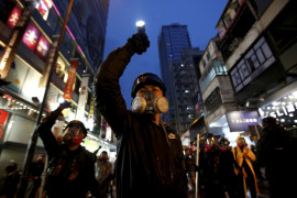 fot. Willy Kurniawan. Protestujący przeciw ustawie o ekstradycji kierują swoje latarki w stronę kordonów policji tłumiących zamieszki. Hong Kong, Chiny, 25 sierpnia 2019 / Pulitzer Prize for Breaking News Photography 2020